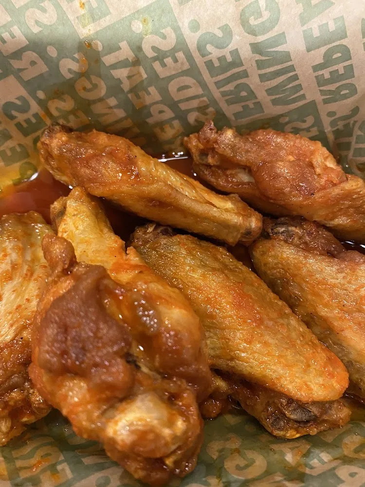 Wingstop food and storefront view at 2918 W Grand Pkwy N. in Katy, Texas