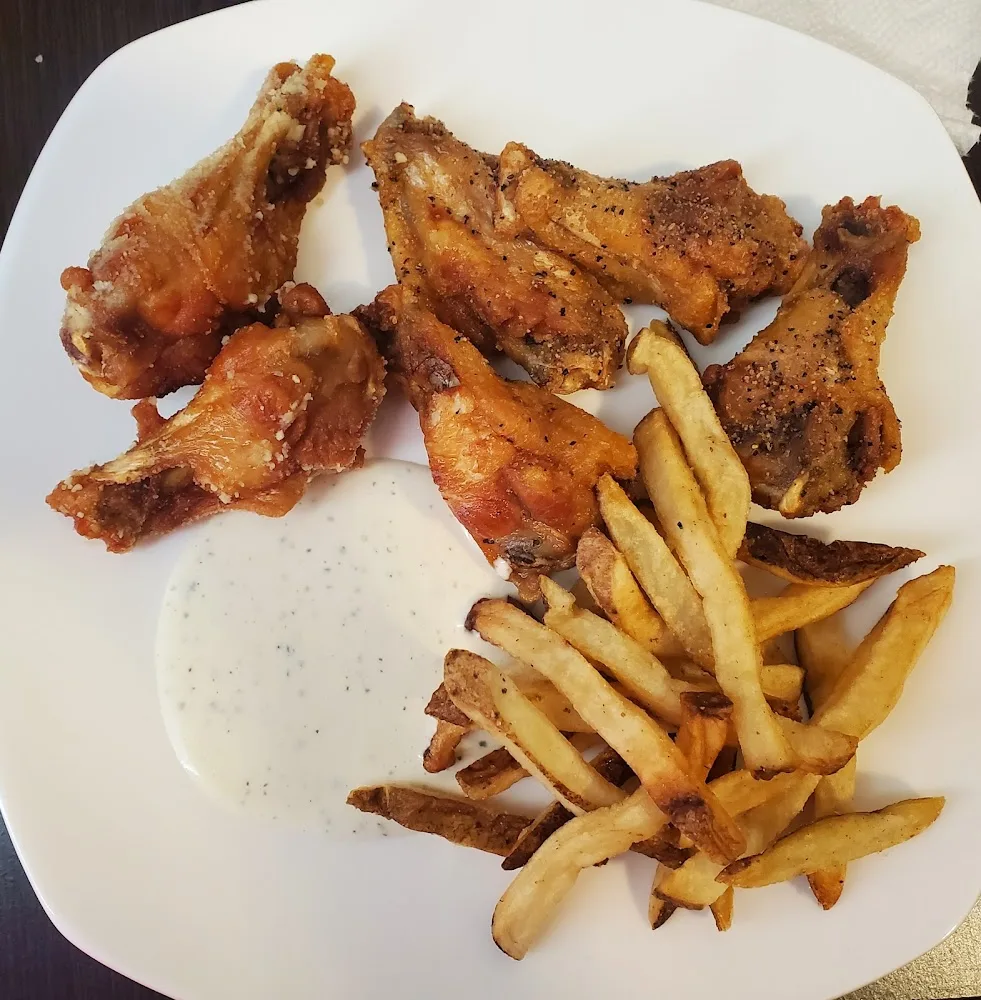 Wingstop food and storefront view at 19431 Morris Ave Suite 130 in Manvel, Texas