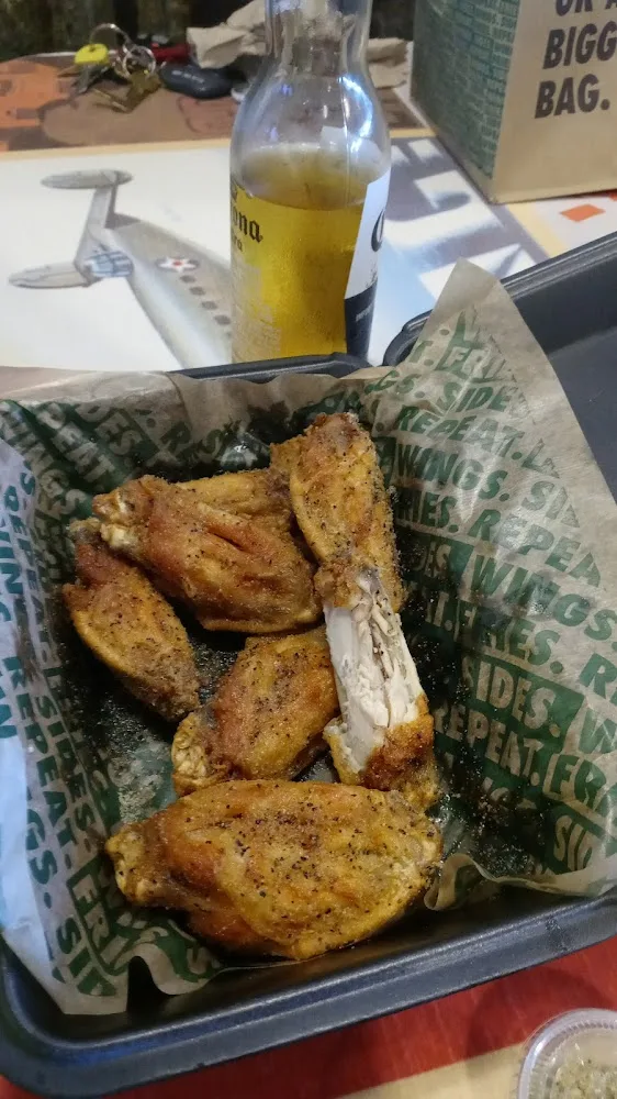 Wingstop food and storefront view at 8321 Broadway St Ste 104 in Pearland, Texas