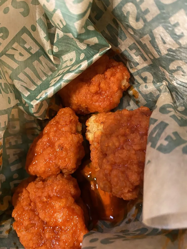 Wingstop food and storefront view at 12568 Broadway St in Pearland, Texas