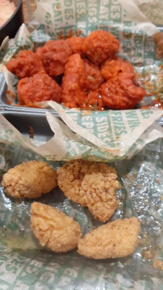 Wingstop food and storefront view at 2211 S Cage Blvd in Pharr, Texas