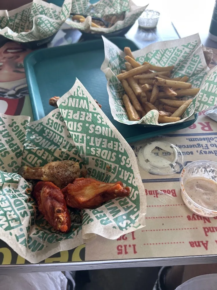 Wingstop food and storefront view at 3309 Dallas Pkwy Ste 499 in Plano, Texas