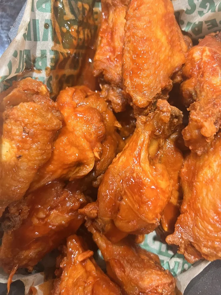 Wingstop food and storefront view at 18426 Kuykendahl Rd in Spring, Texas