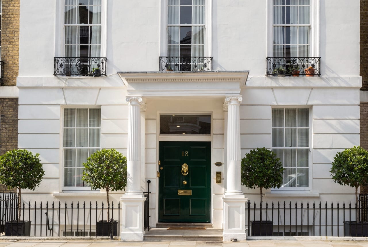 No. III — a white-stucco Belgravia town house with a green front door.