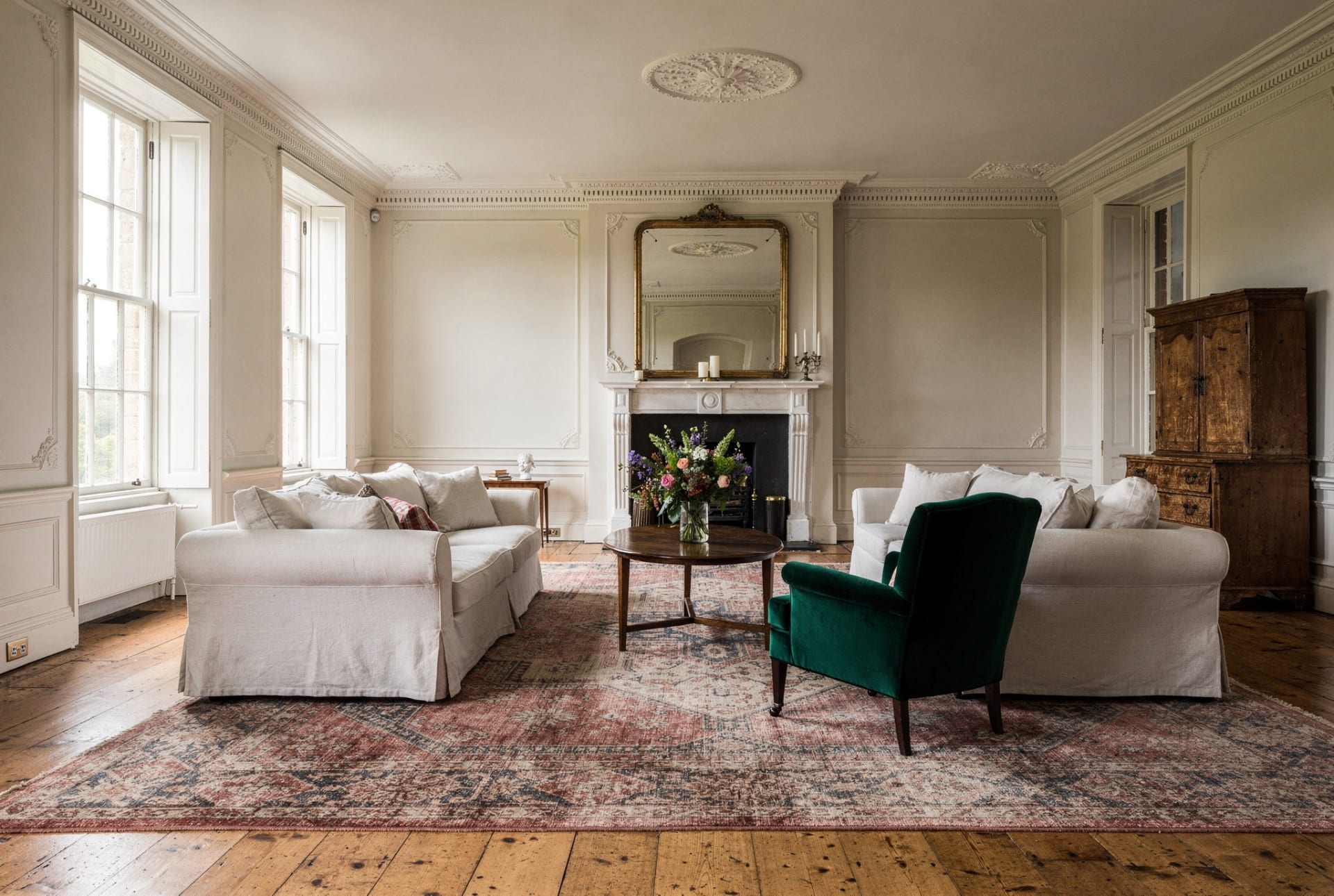 A grand, light-filled Georgian reception room with tall sash windows.