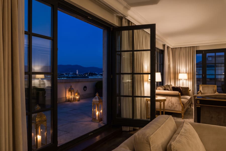 The Terrace Suite opening onto a private terrace at dusk.