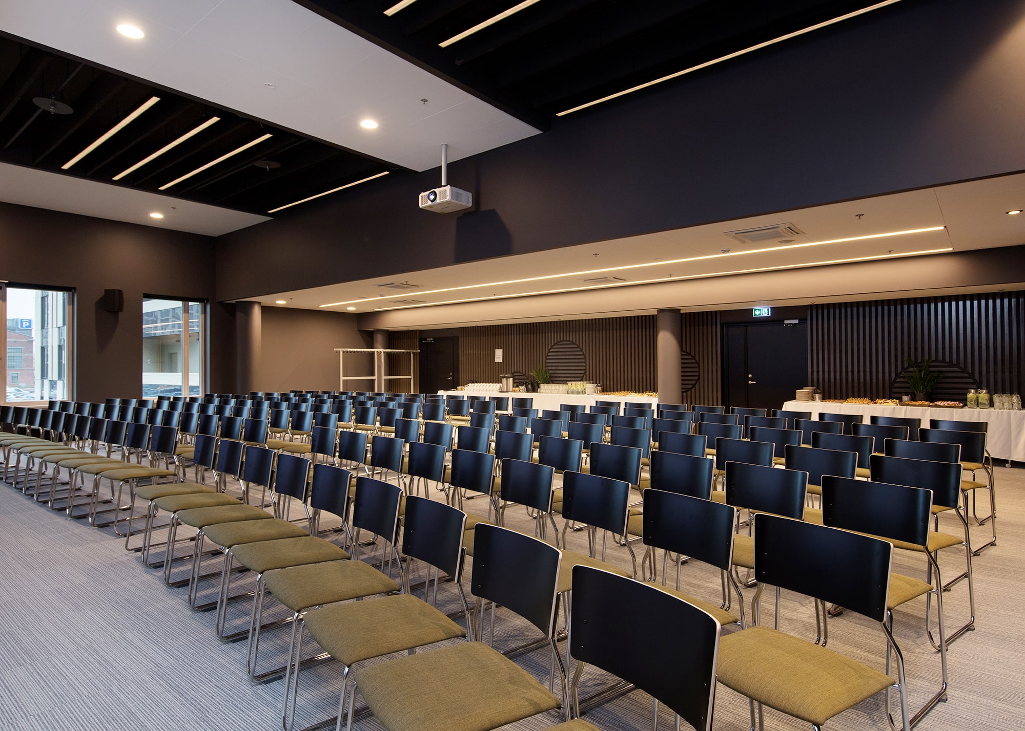 Newly opened seminar room for 180 persons on the 2nd floor of Öpiku building in Ülemiste campus. The room is modern and well-equipped: projector and 300x540cm screen, 4x220W wall-mounted speakers, Barco ClickShare system, free WIFI, white board and markers, paper and pencils.