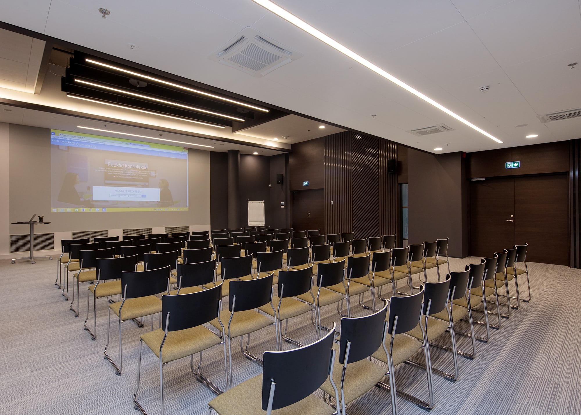 Newly opened seminar room for 140 persons on the 2nd floor of Öpiku building in Ülemiste campus. The room is modern and well-equipped: projector and 346x616cm screen, 4x220W wall-mounted speakers, Barco ClickShare system, free WIFI, white board and markers, paper and pencils.