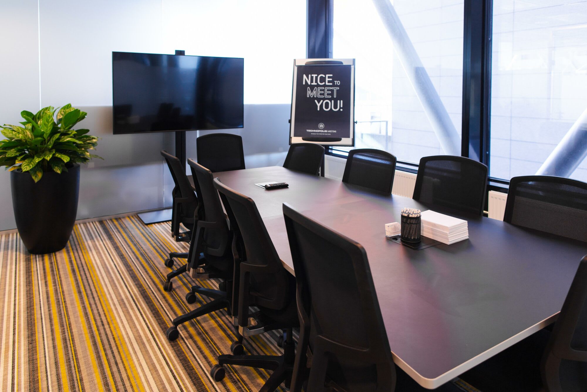 Meeting room for 10 persons with a diplomat table. The room is equipped with a screen and videocamera.