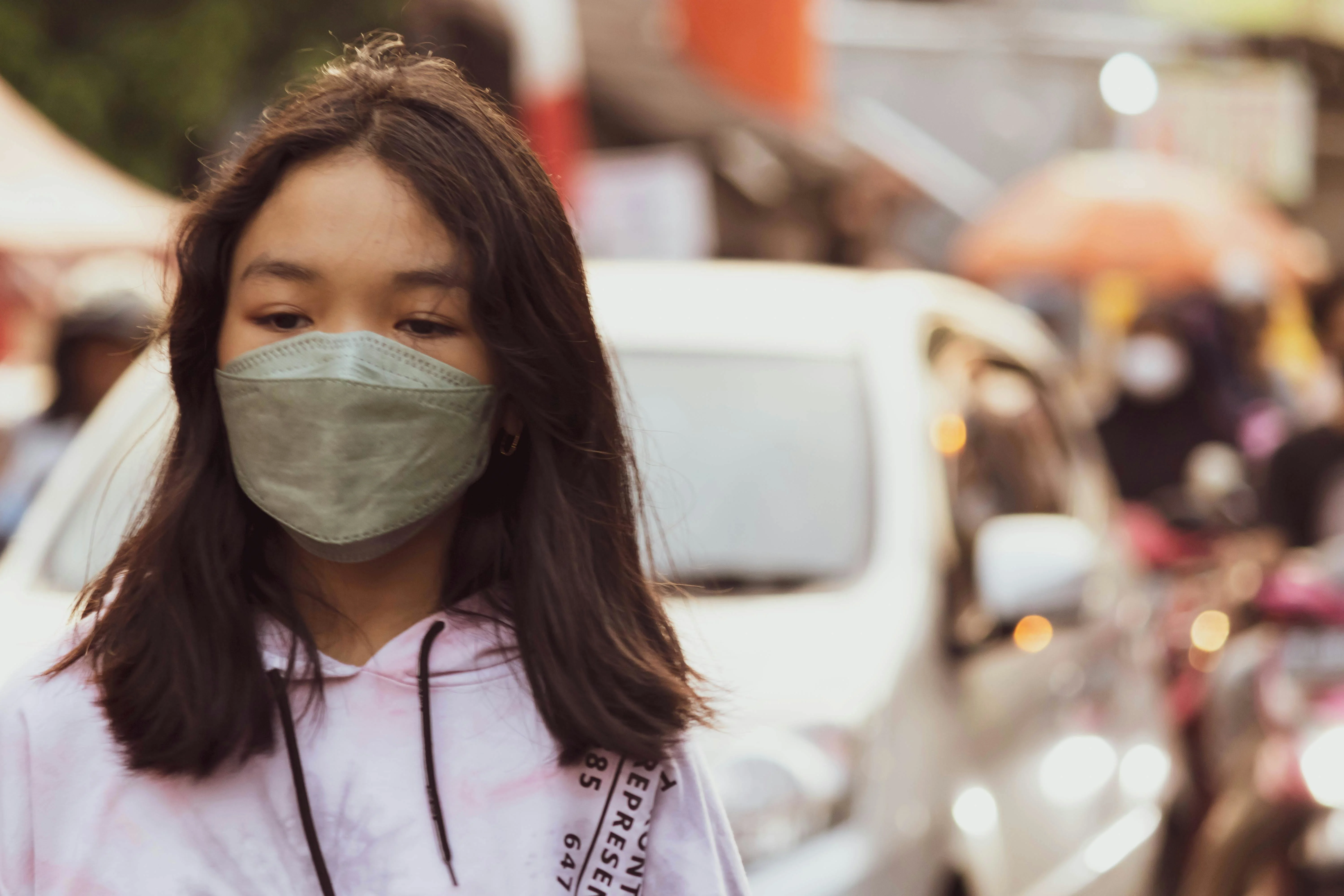 A teenage girl wearing a face mask