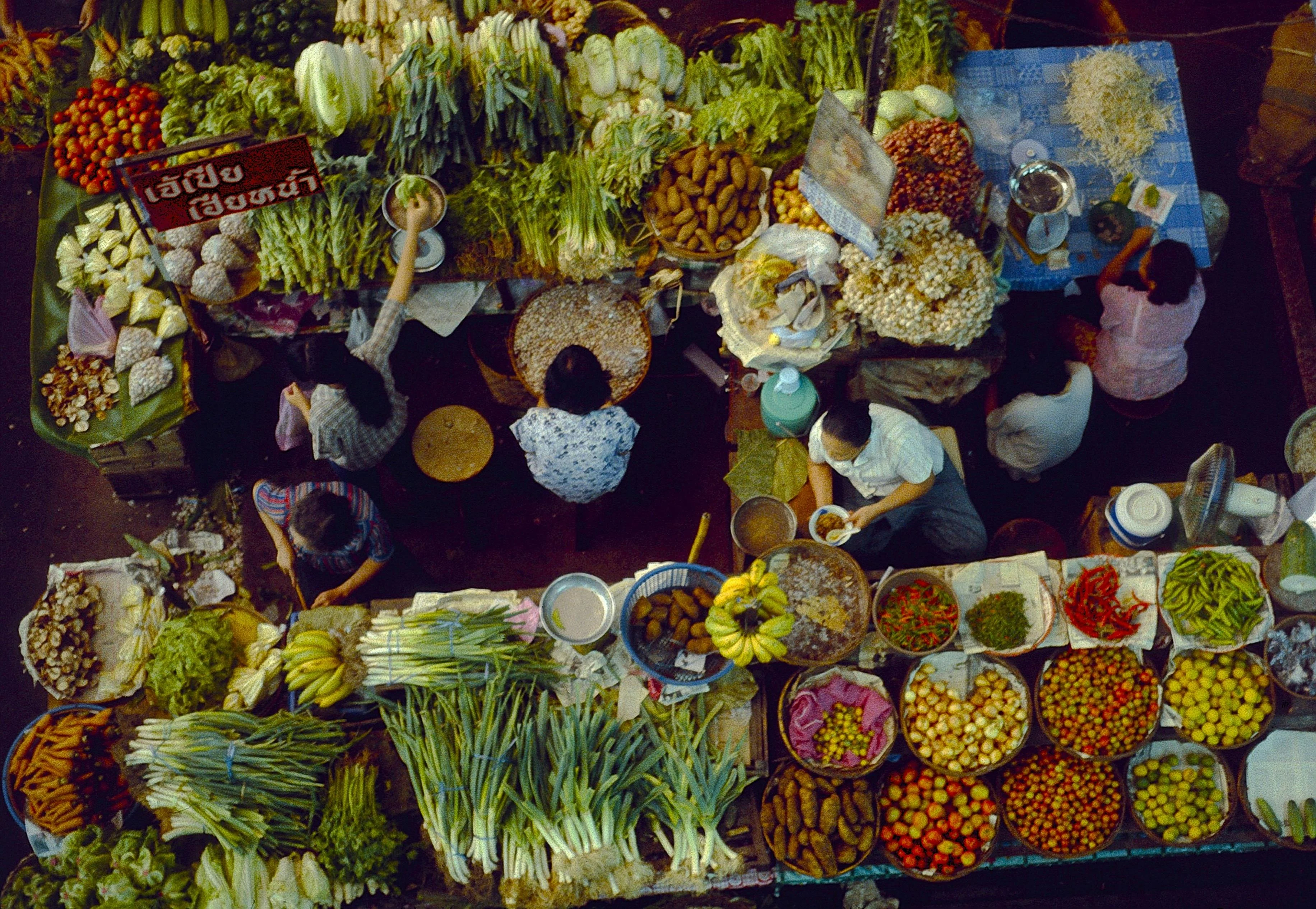 A bustling top-down view of a fresh produce market in Chiang Mai, Thailand. More info Share