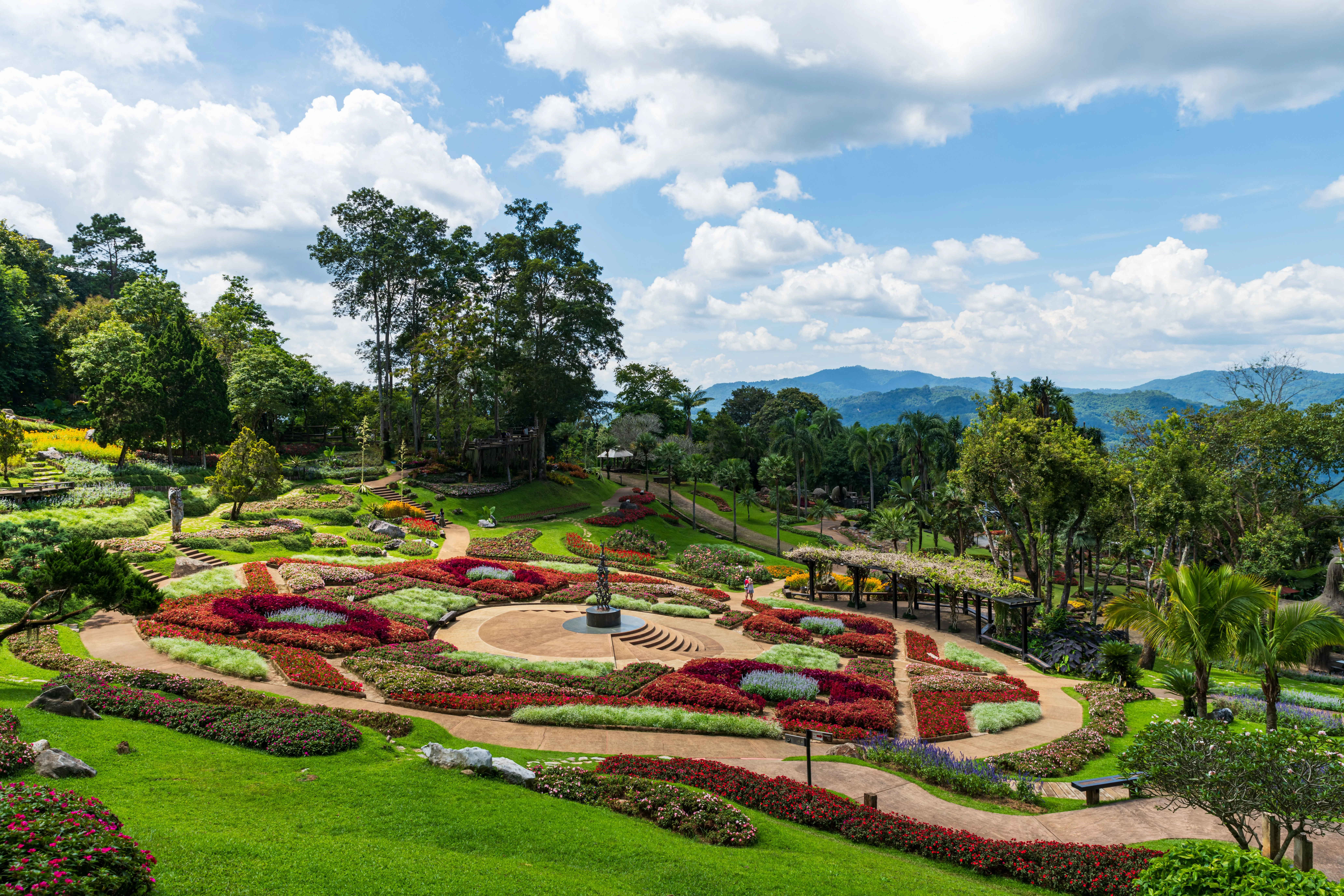Stunning landscaped garden at Doi Tung Royal Villa, Chiang Rai, Thailand, surrounded by lush greenery and mountains