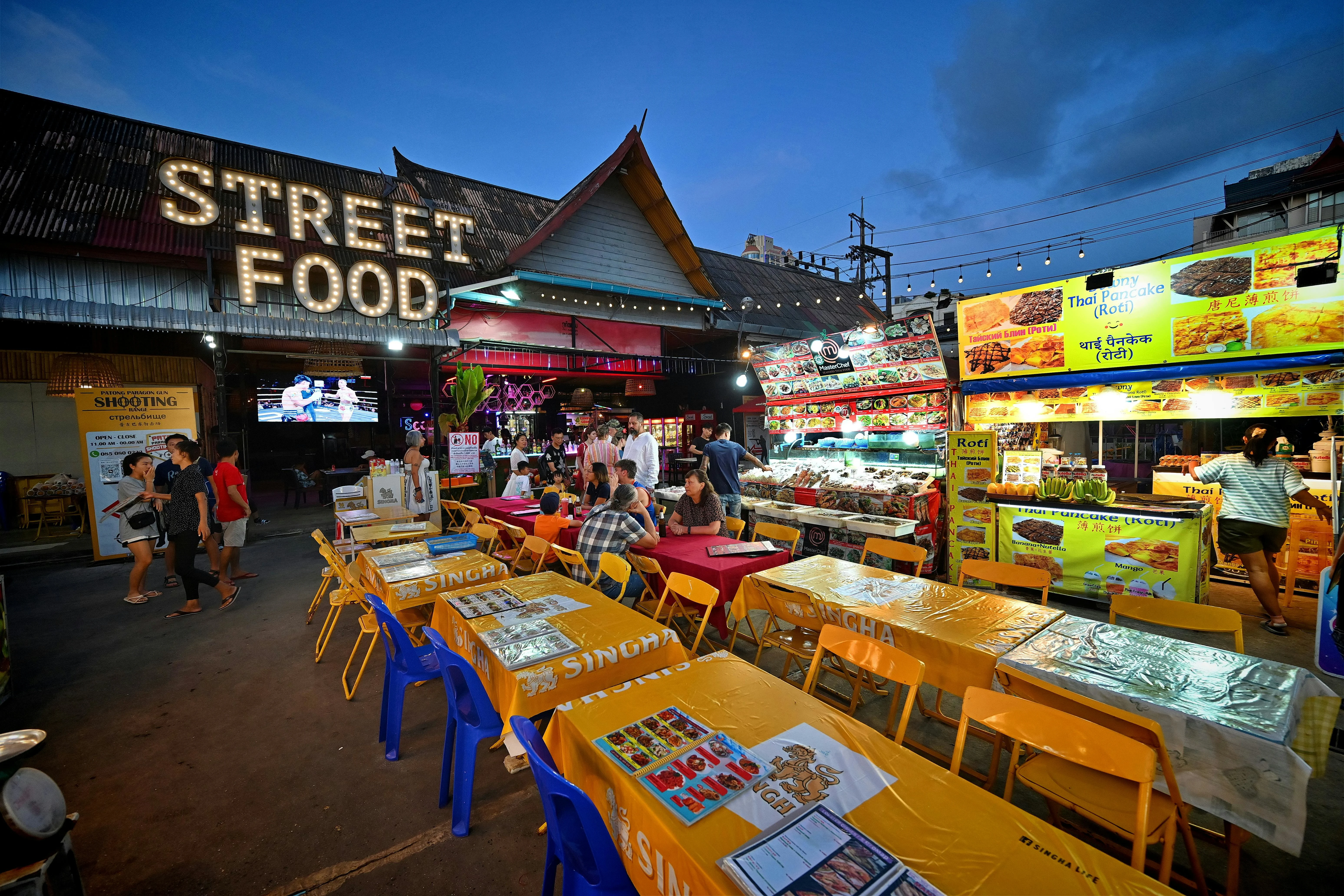 Bustling night market with colorful street food stalls in Patong, Phuket, showcasing vibrant Thai culture