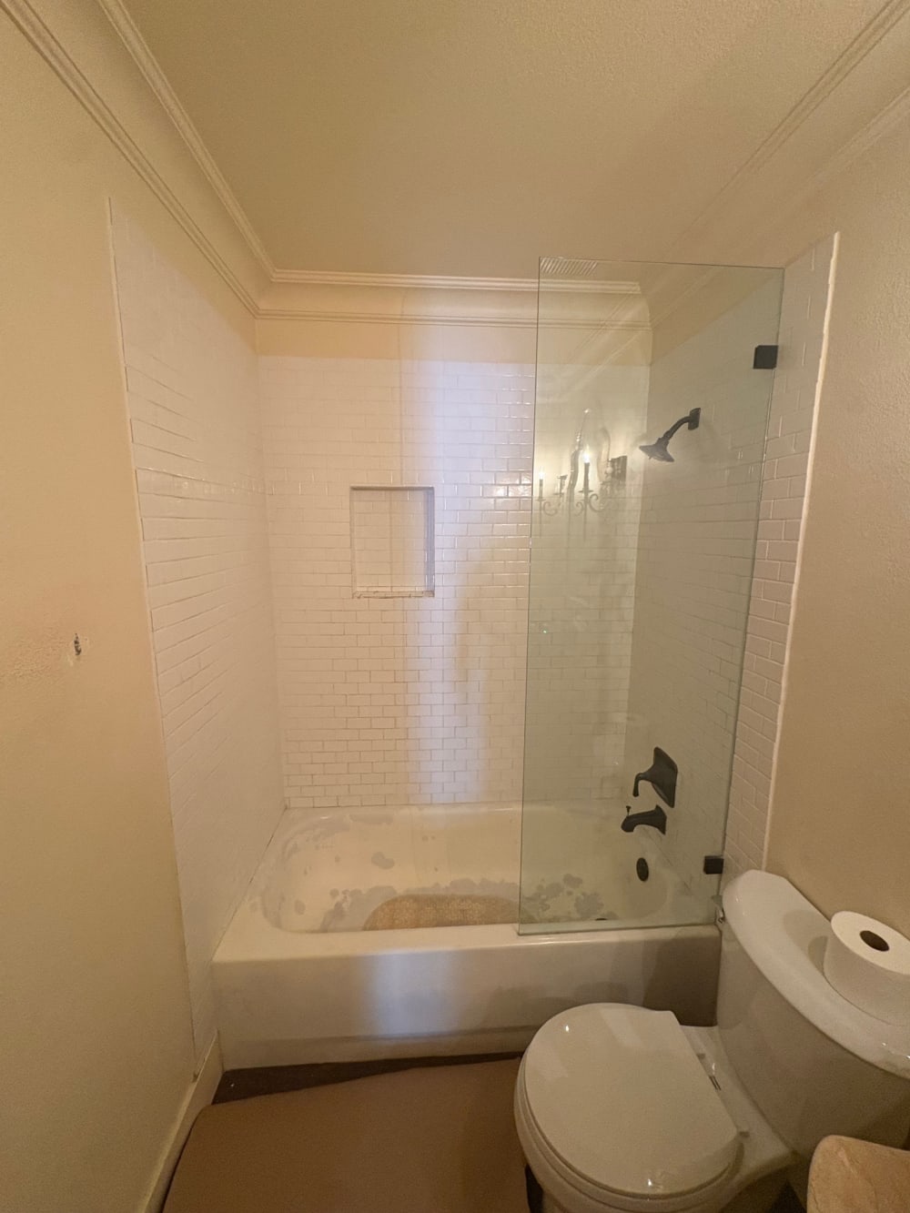 Outdated bathtub with worn tile before Las Vegas bathroom remodel by EZ Bath & Shower