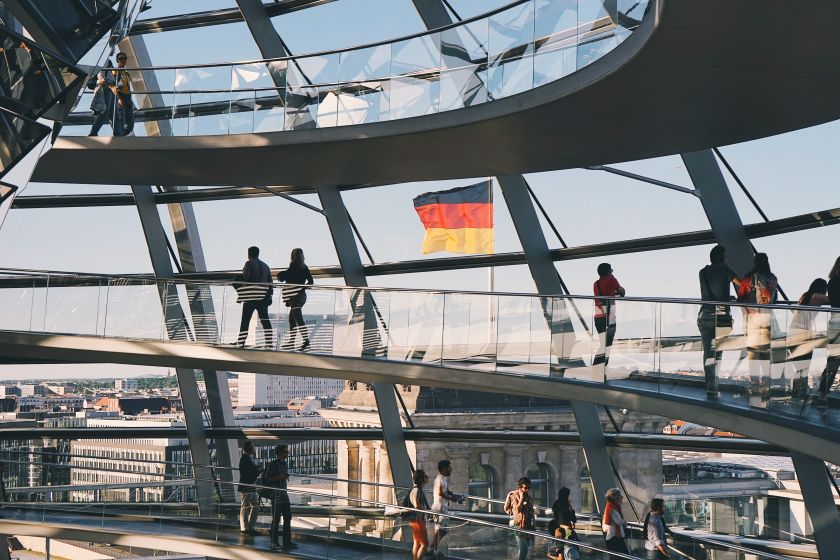 The Reichstag building in Berlin, German flag in the background