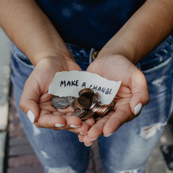 Image of a woman with her hands full of change