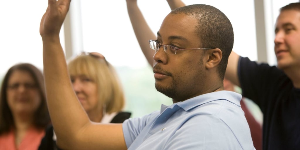 a panel of people raising their hands