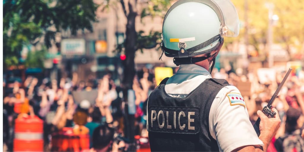 police person facing away from camera towards a crowd