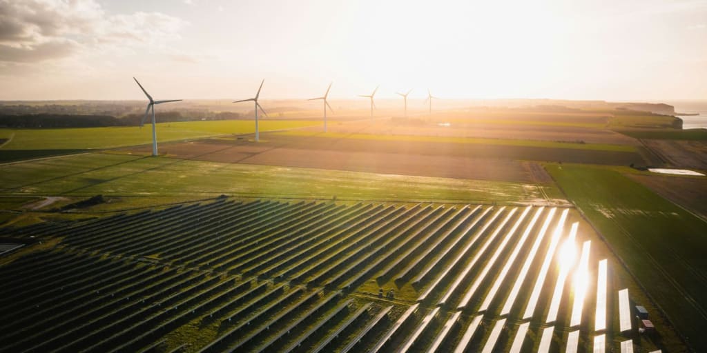 a field with solar panels representing net zero carbon emissions