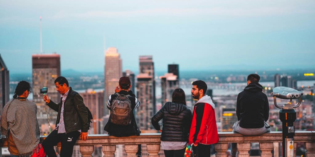 a group of people looking out over a city skyline