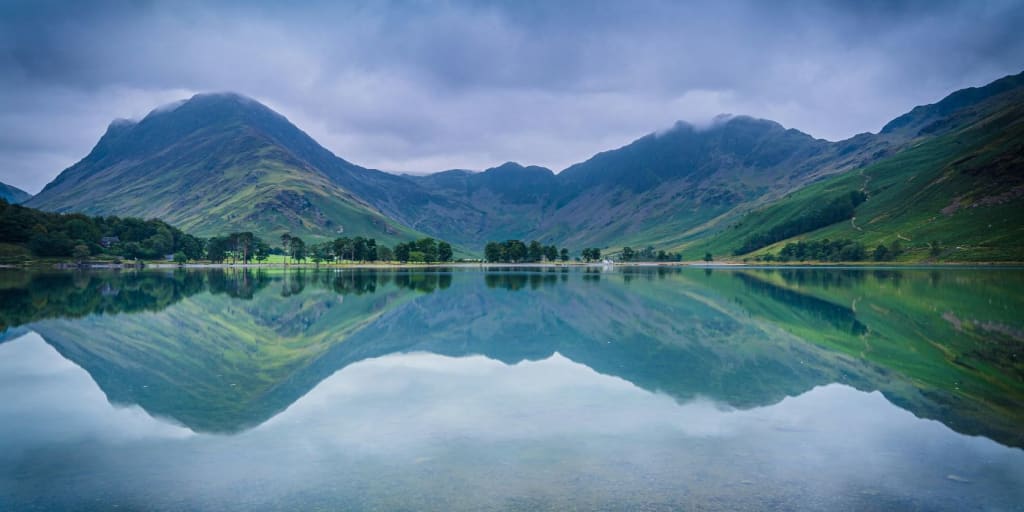 landscape across a peaceful lake with clear reflection