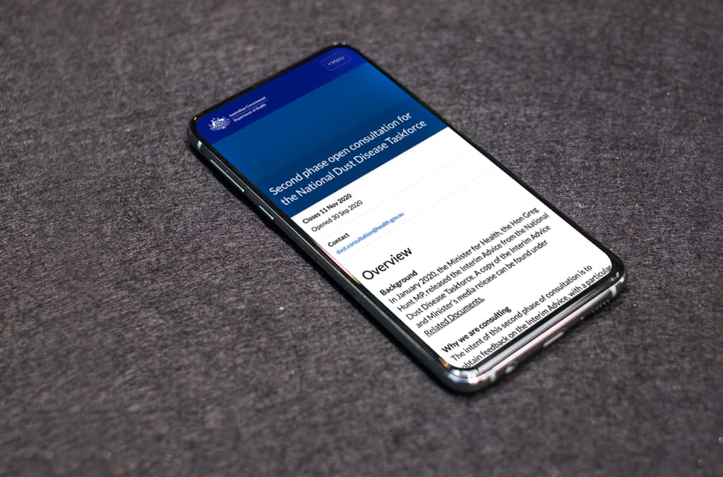 Phone displaying overview page of Australia Department of Health's consultation, title 'Second phase open consultation for the National Dust Disease Taskforce'