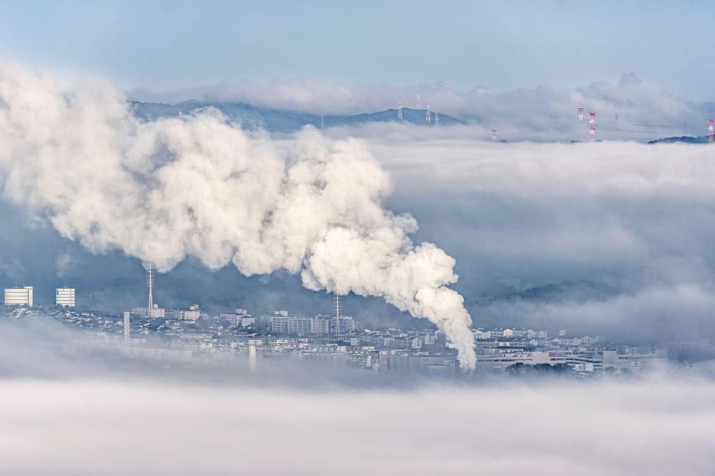 city surrounded by pollution smoke