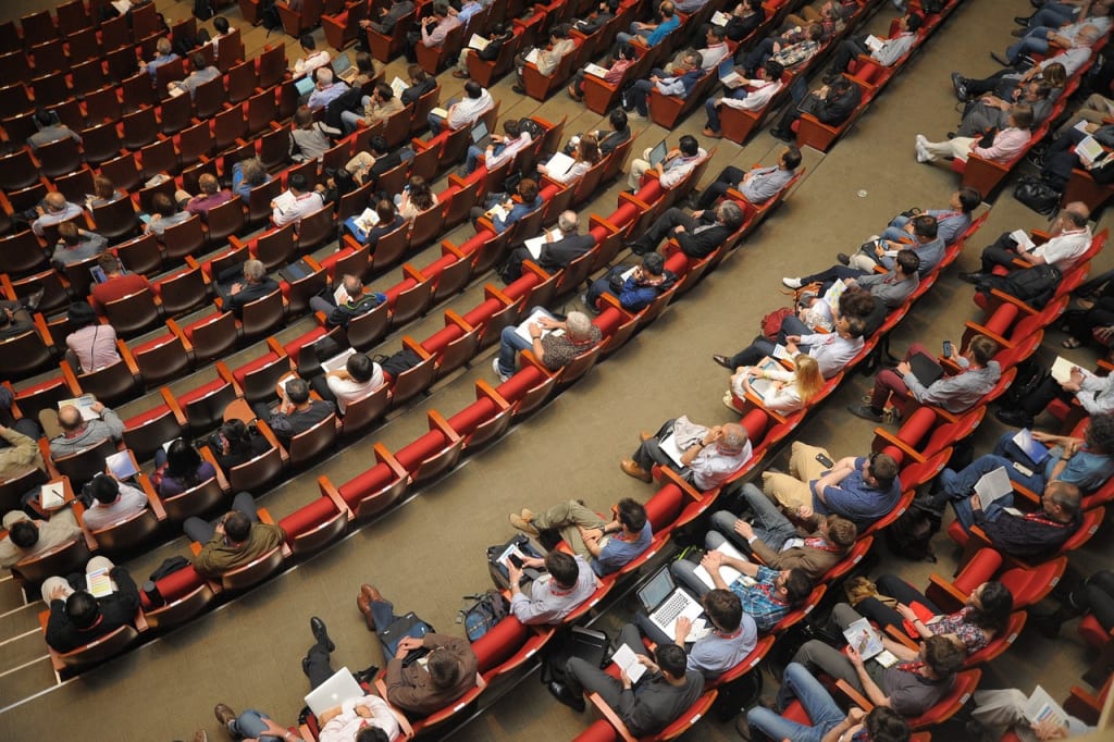citizens assembly ,birds eye view looking down at people sat in theater ready to discuss