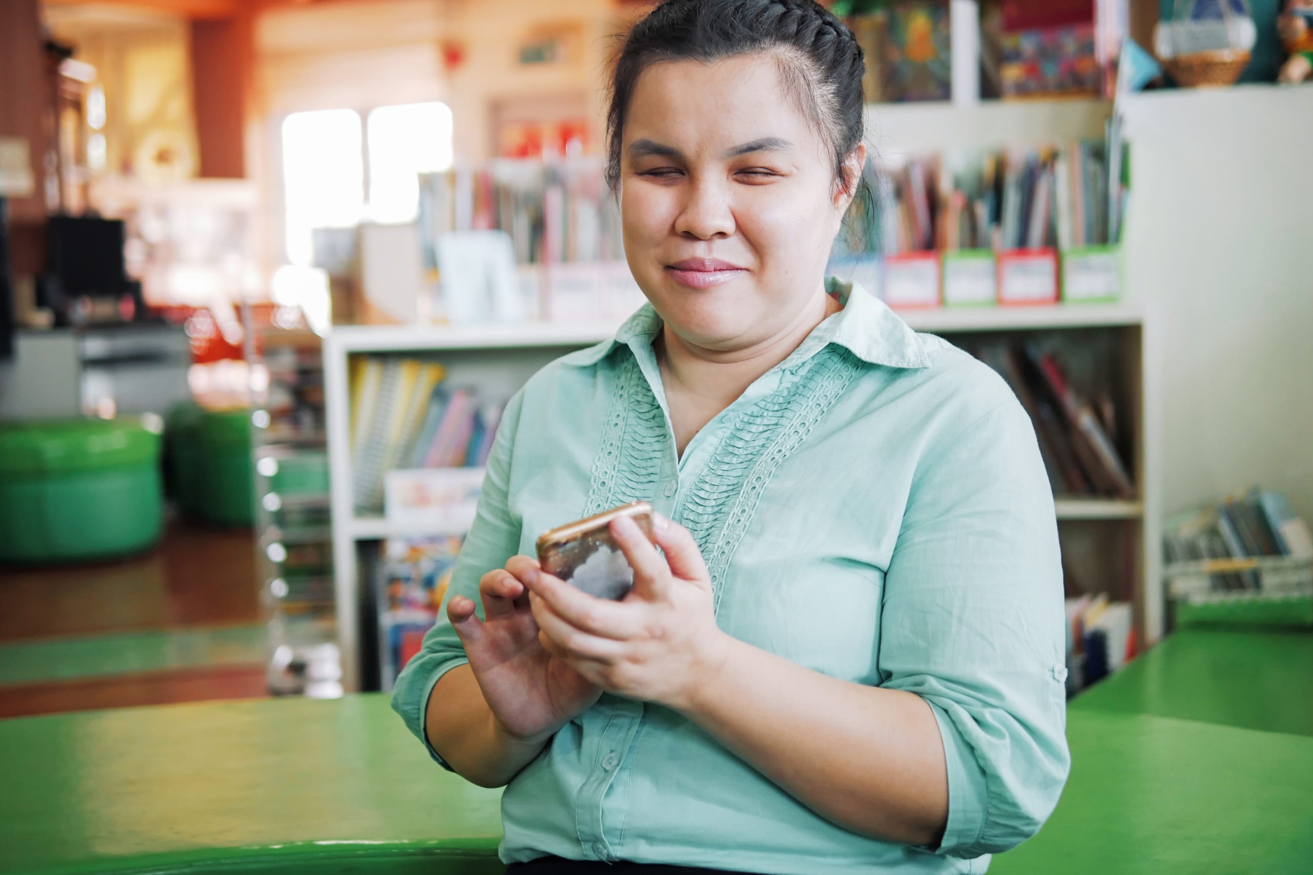 Portrait of Asian young blind woman using smart phone with voice accessibility