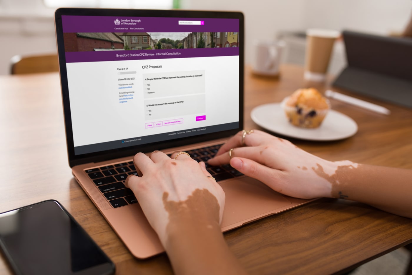 Woman's hands typing on a laptop displaying a Citizen Space consultation