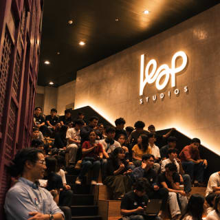 A full house on the Amphitheater steps under the lit LEAP sign