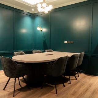 Luna meeting room: a round-ended table in a deep green room