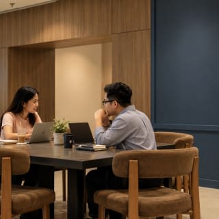 Two people working together at a table on the ground floor