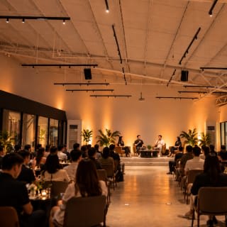 A panel talk at LEAP Studios, the audience seated in a warm-lit hall