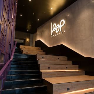 The lit LEAP Studios sign above the stairs at the entrance