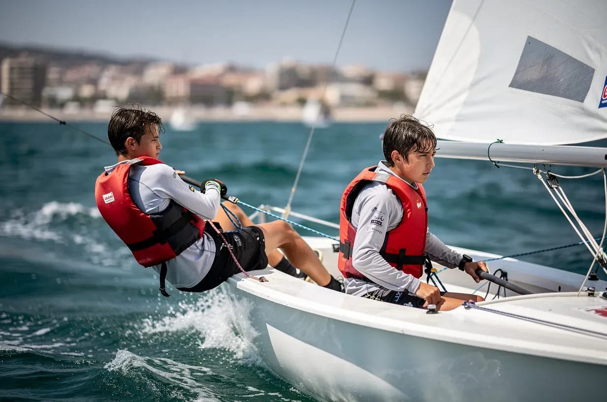 Pair of teenage sailors training in a 420 dinghy off the coast of Alicante