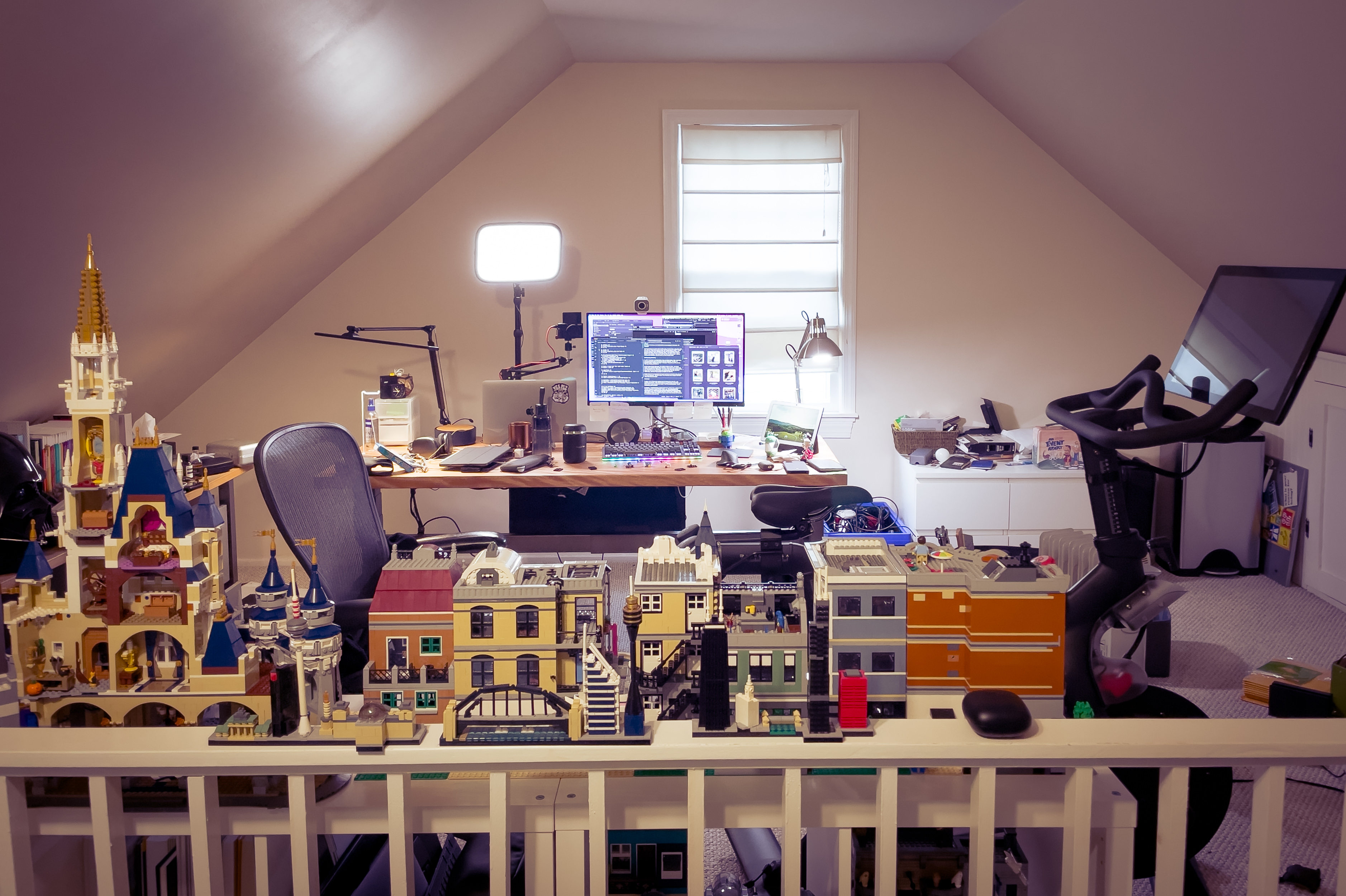 My attic studio space in its final WFH configuration, January 2021 Desk, Peloton bike, and Lego sets
