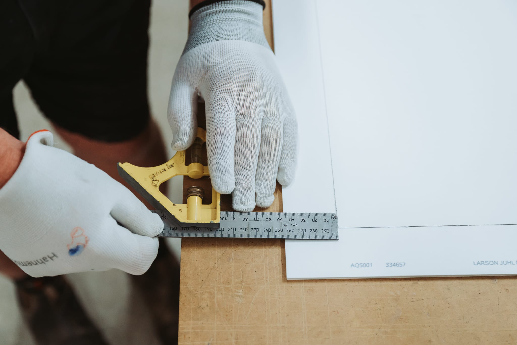 Mat board being cut in the workshop