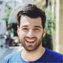 Headshot of Tobias in front of a small shop