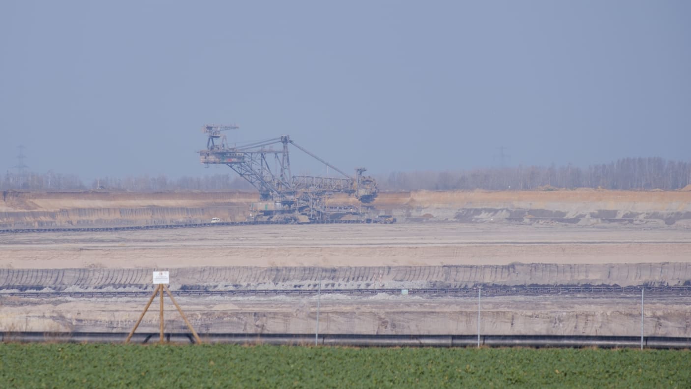 Green area with open mine and huge digger in the background