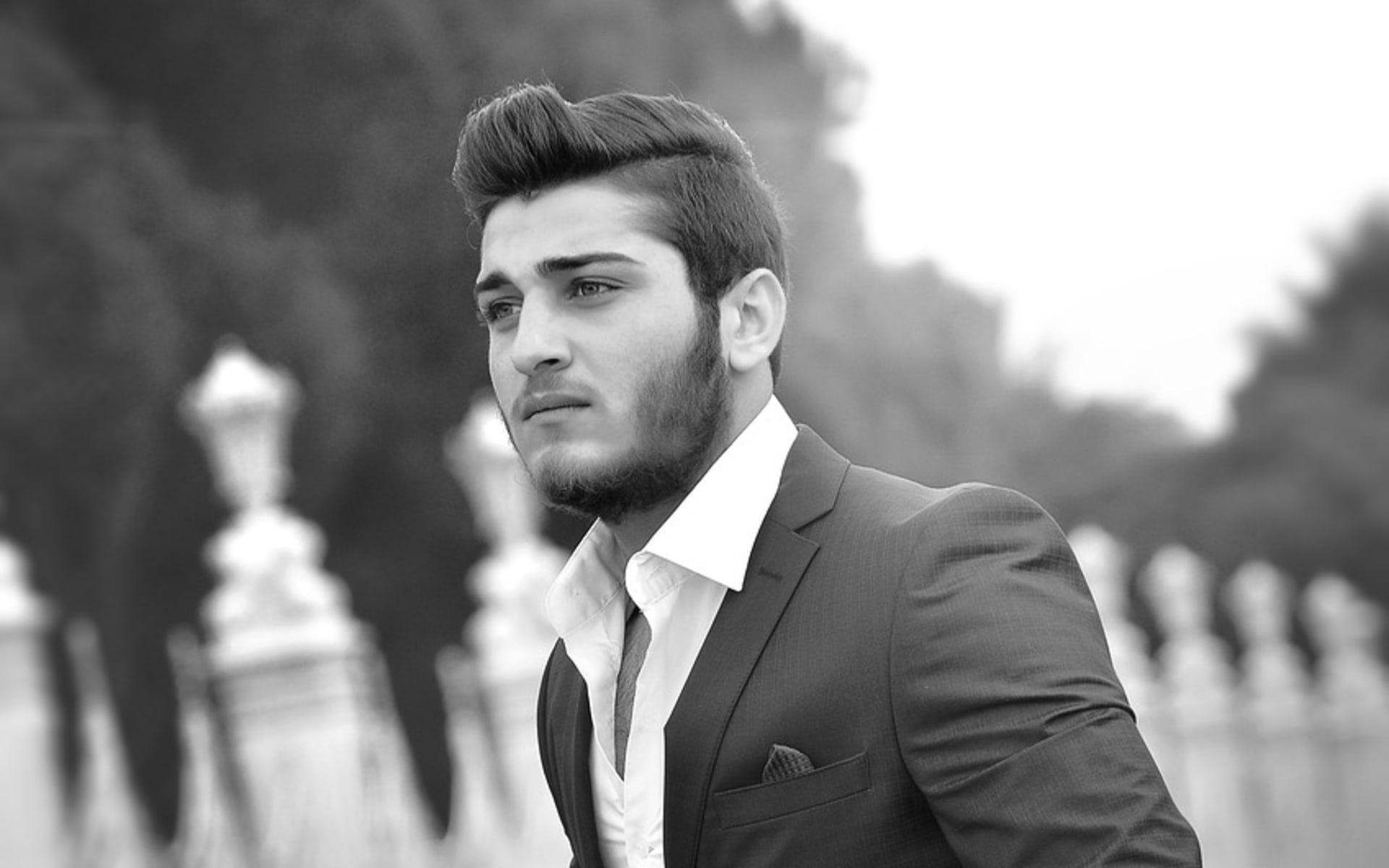 Man wearing a high-quality blue suit, now grayscaled