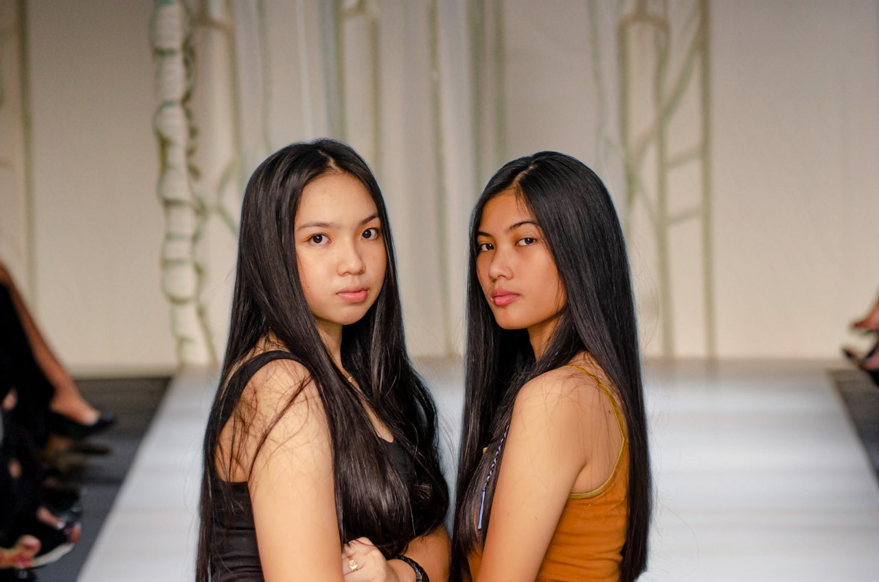 2 women fashion runway background