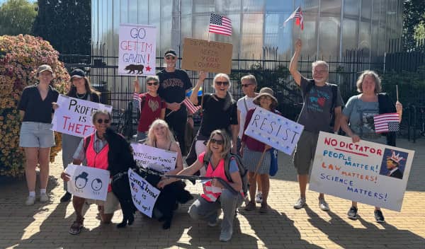 The protest group poses in front of the monument in People's Park, Malmö.