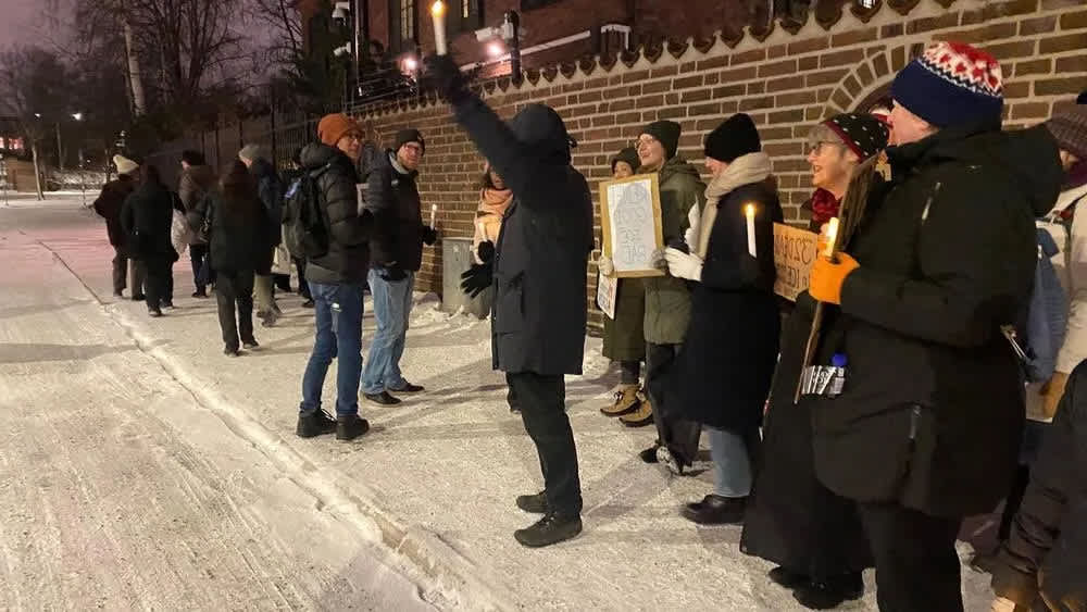 Protesters stand outside the US embassy in Stockholm.