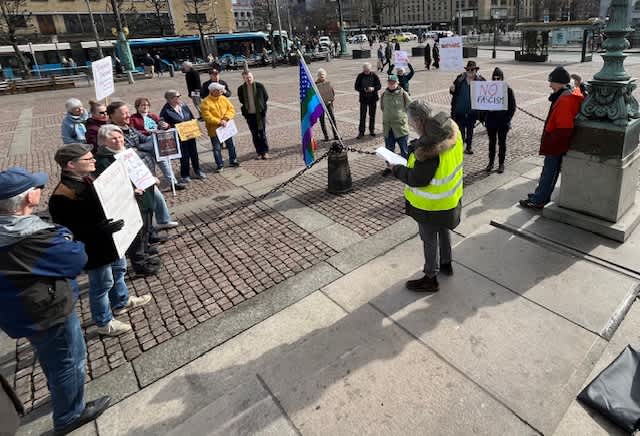 The protesters gather in a circle to listen to one of the speakers.