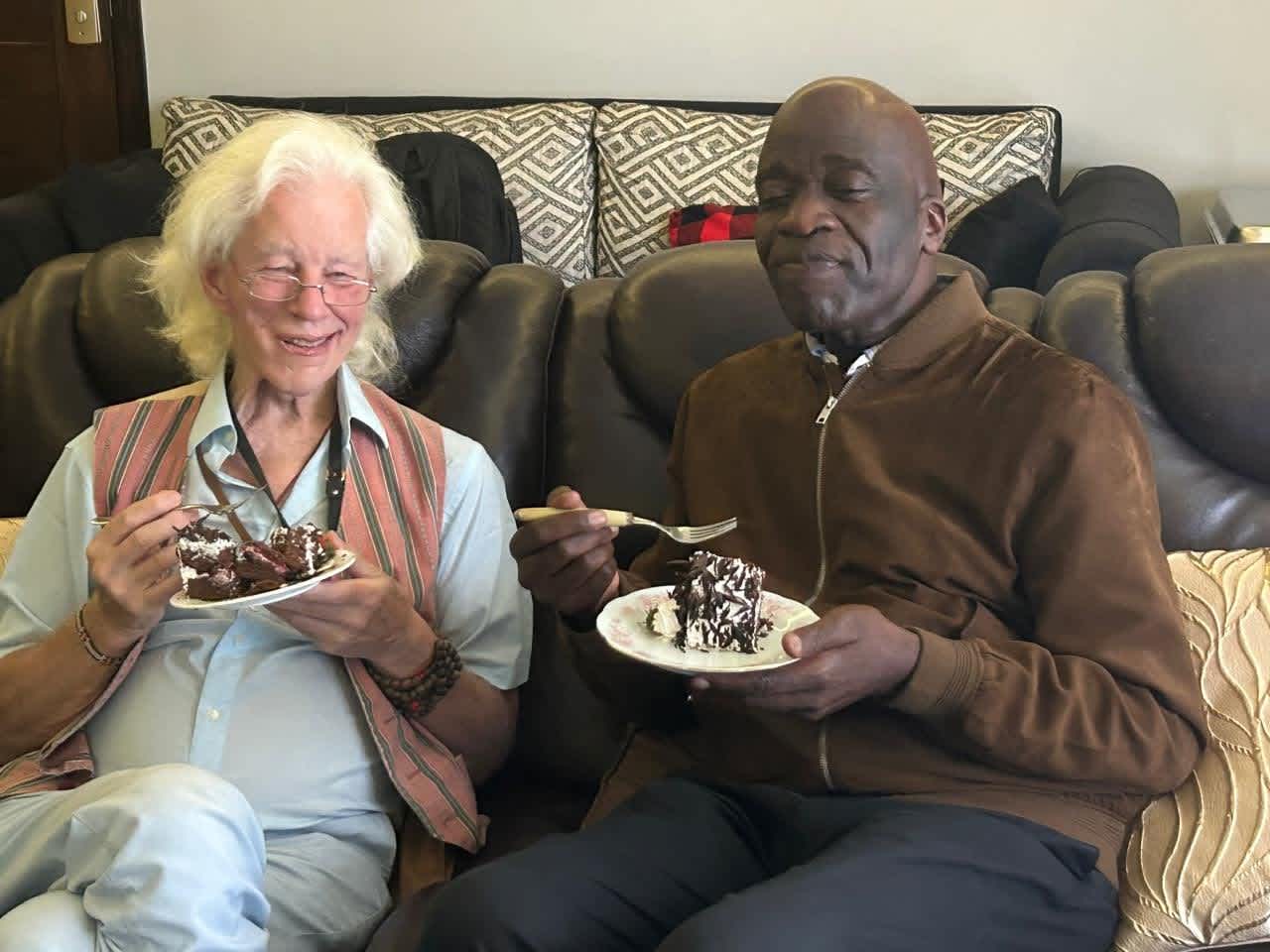 Speaker Rick Wicks enjoying chocolate cake with a friend.