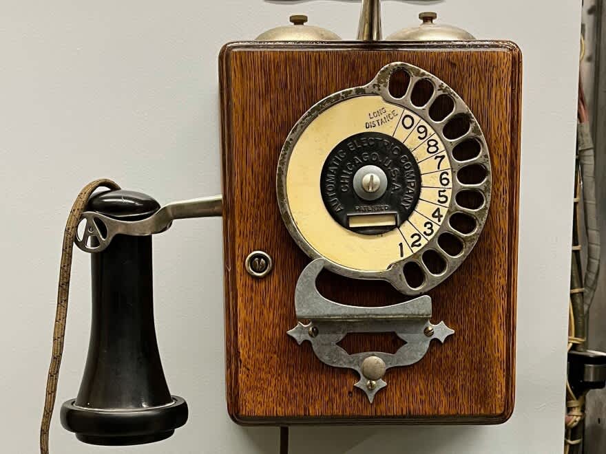 A very old wall-hanging phone.