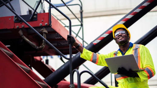 Engineer in hard hat reviewing plans