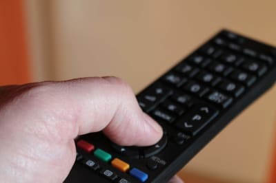 hand holding remote