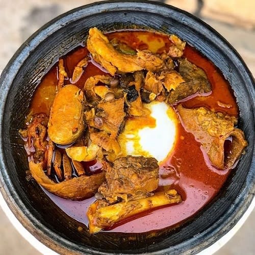 Fufu With Palmnut Soup With And Assorted Protein (Fish, Goat Meat, Chicken, Snail And Crab)